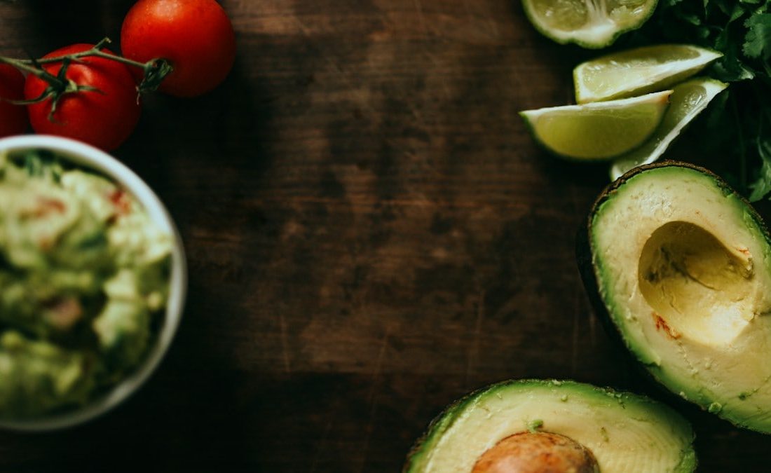 sliced green cucumber and red tomato on brown wooden table