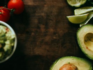 sliced green cucumber and red tomato on brown wooden table