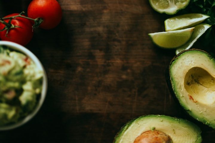 sliced green cucumber and red tomato on brown wooden table