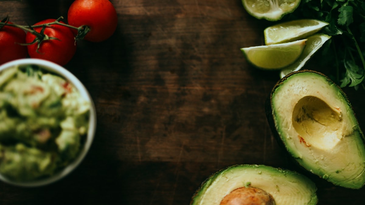 sliced green cucumber and red tomato on brown wooden table